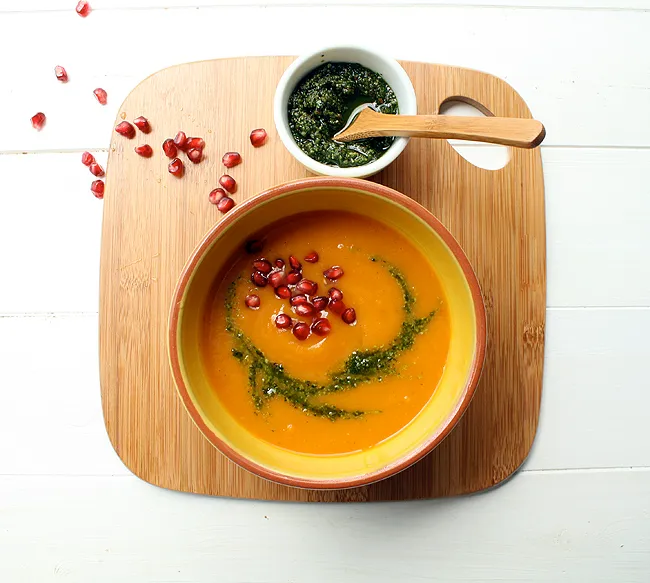 butternut squash soup with cilantro pesto and pomegranate seeds