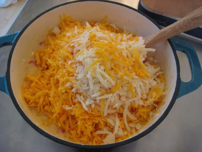 stirring cheese into mac